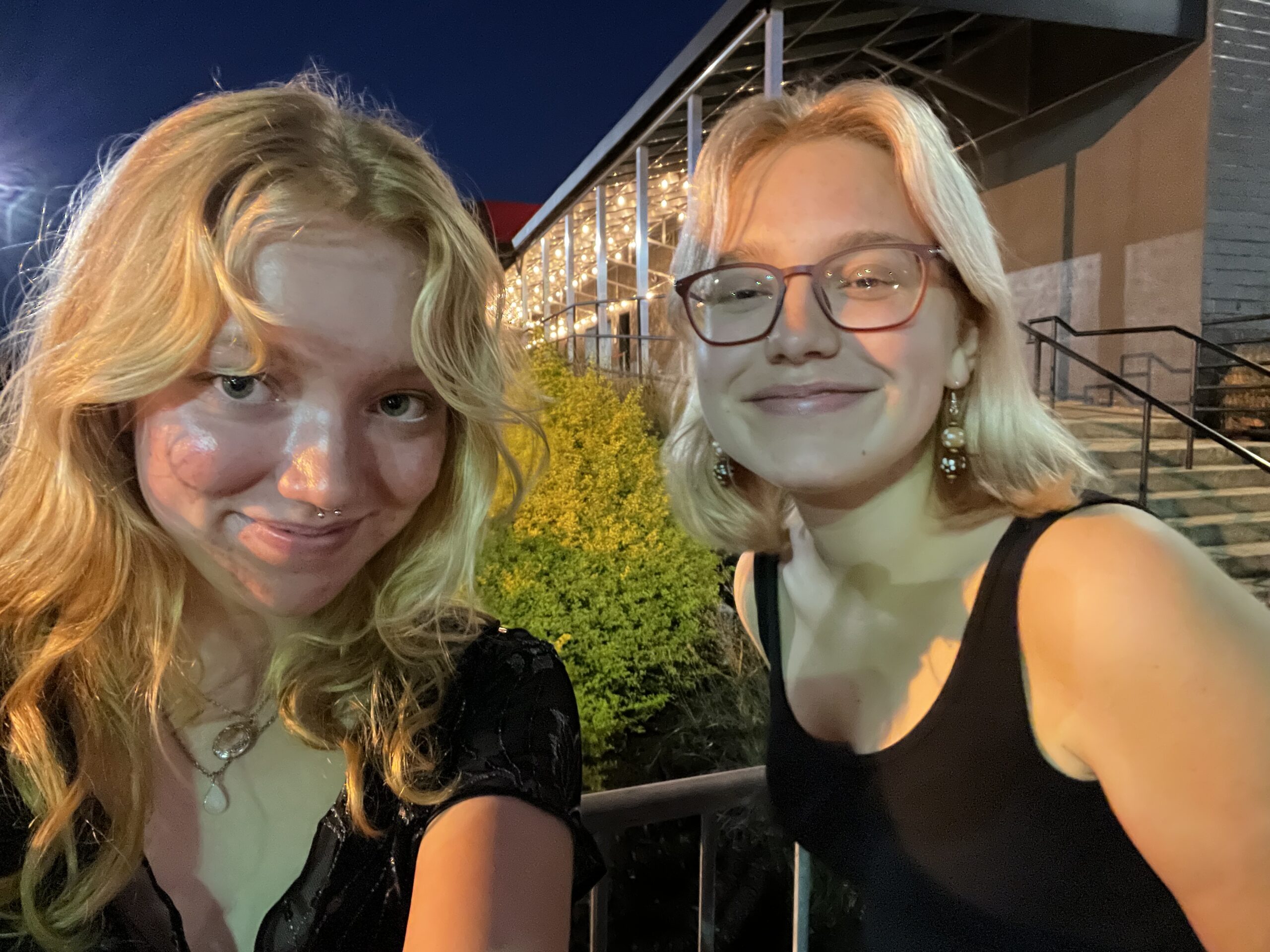 Eliza and Psalter smile at a concert.