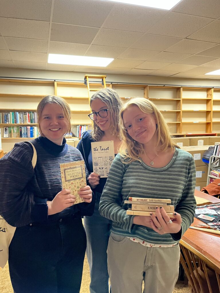 Eliza and friends pose with books from Al's bookshop.