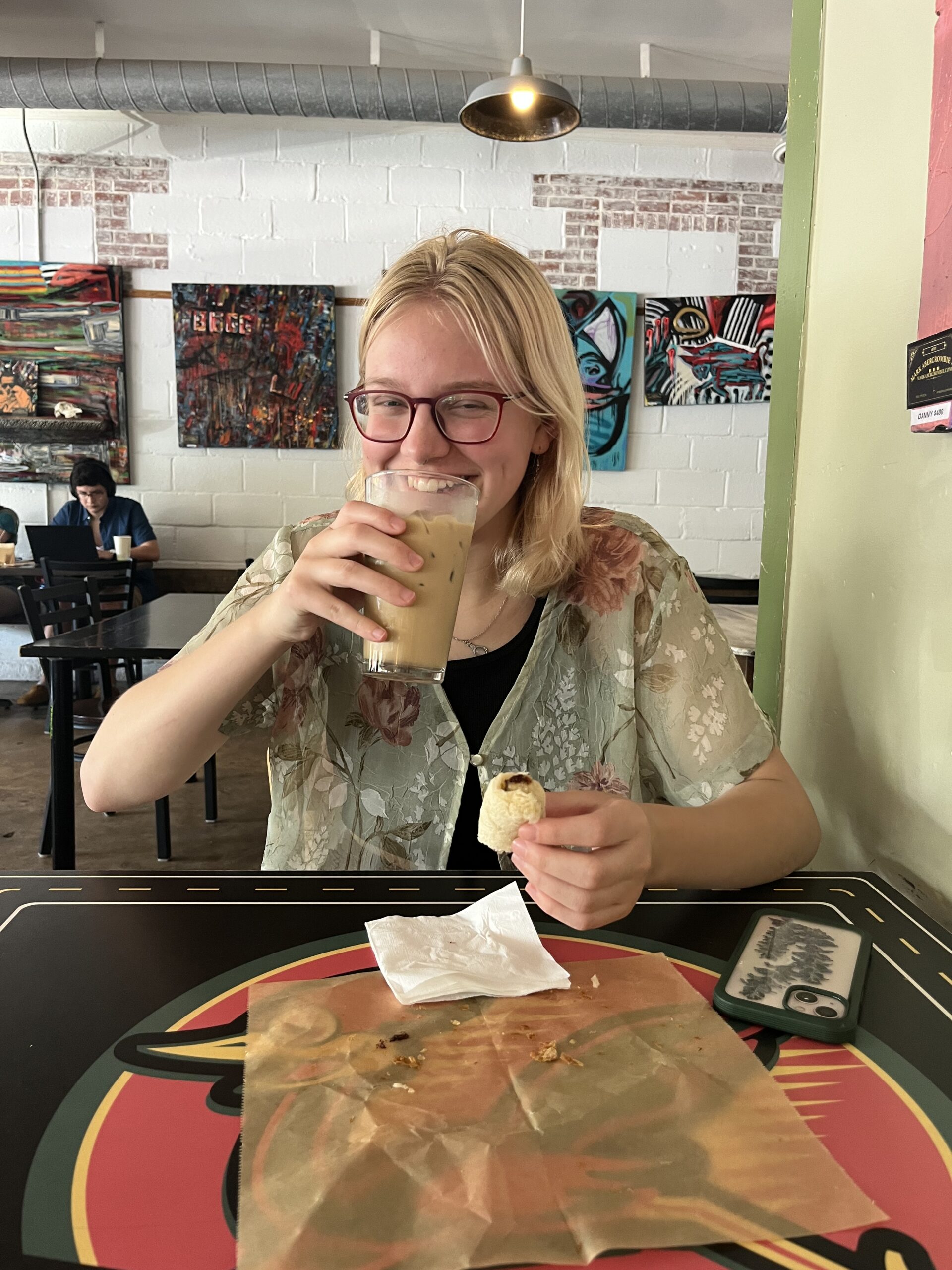 Psalter smiles with an iced coffee.